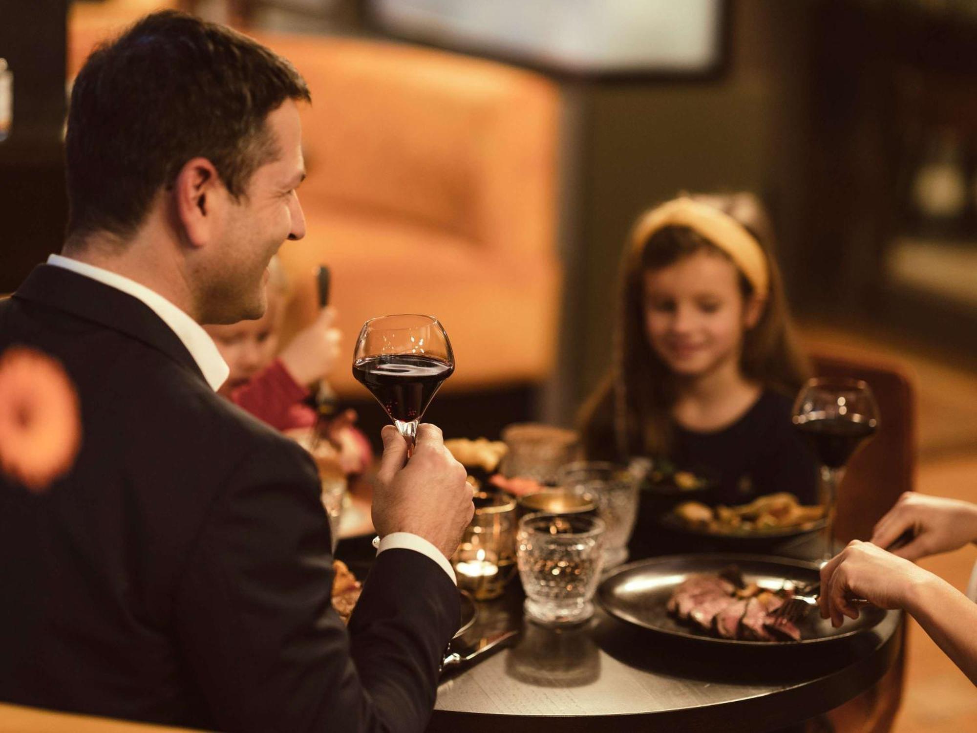 Sofitel Luxembourg Europe Hotel Bagian luar foto A man drinking wine